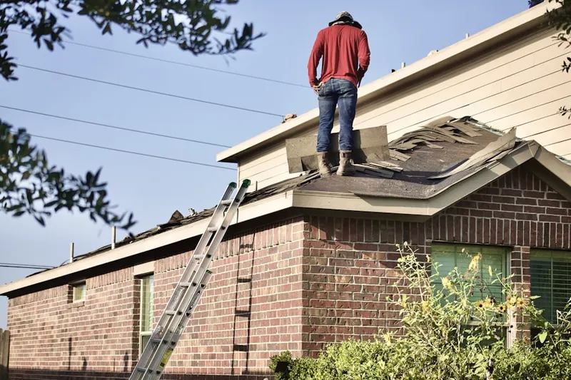 Professional roofer working on a residential roof in West Hartford